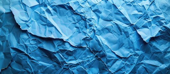 Fototapete - Background with blue crumpled paper texture providing copy space image.