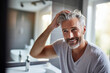 © Olga Miltsova - mature man styling his hair looking in mirror, Generative AI