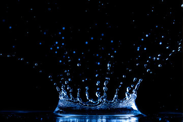 Wall Mural - water splash isolated on the black background