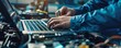 © ALEXSTUDIO - Mechanic utilizing a laptop for vehicle diagnostics during repairs in a garage