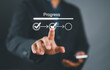 © Nirusmee - Businessman touching to tick correct mark in checklist with progressive loading status to remind work task progressive for project develop management and tracking concept.