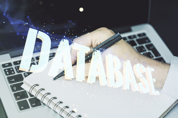 Wall Mural - double exposure of creative database word hologram and hand writing in diary on background with lapt