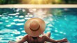 © ibooM - A woman lounging on a poolside chair, wearing a wide-brimmed hat.