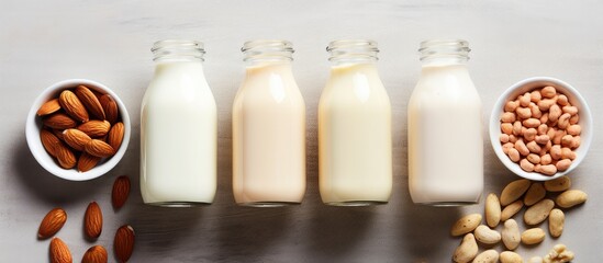 Aufkleber - Assorted plant-based milk options like almond and cashew displayed on a table with a top view, suitable for a copy space image.