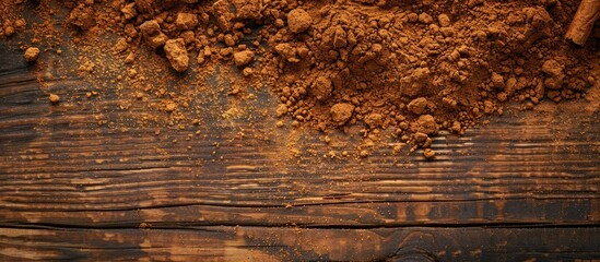 Leinwandbilder - Close-up of fragrant ground cinnamon powder on a textured wooden background, perfect for baking, desserts, and drinks, with a spacious area for text or images. with copy space image