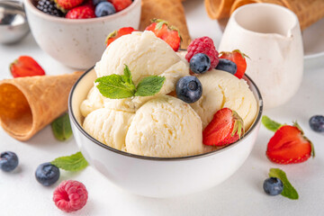 Wall Mural - White ice cream bowl with vanilla gelato and fresh berries. Big portion of classic vanilla taste ice cream, with strawberry, raspberry, blueberry, blackberry, and waffle ice cream cones