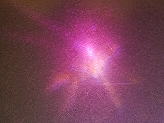 Wall Mural - pink light reflections on a plastic sheet in the dark for an abstract background.