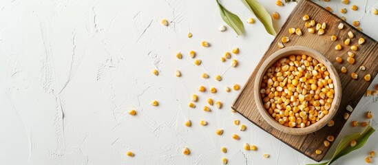 Poster - Organic corn on a wooden board isolated on white background with copy space image.