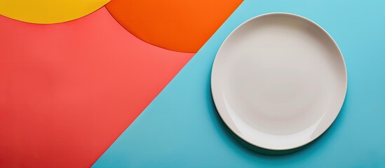 Poster - Top view of a pristine plate on a colorful background, with space for additional images
