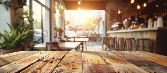 Poster - Wooden table with empty surface and a blurred coffee shop background, with a clean, bright foreground for showcasing products in a copy space image.