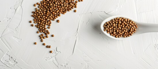 Aufkleber - Brassica hirta mustard seeds in a white spoon on a white background in a studio shot with soft lighting. Top view with copy space image available.
