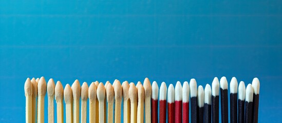 Poster - Close-up view of various new matchsticks on a blue background with copy space image.