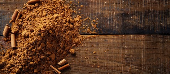 Leinwandbilder - Close-up of fragrant ground cinnamon powder on a textured wooden background, perfect for baking, desserts, and drinks, with available space for text or images. with copy space image