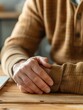 © kazitafahnizeer - Close-up of a man with hand pain rubbing his wrist, office background, clear focus on wrist, large copy space
