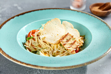 Canvas Print - Gourmet Caesar salad with grilled chicken on a textured backdrop with natural sunlight