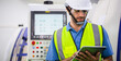 © winnievinzence - Male engineer of technician worker using digital tablet control on modern machine in plant factory. labor and industrial concept