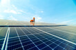 © ultramansk - engineer man inspects construction of solar cell panel or photovoltaic cell by electronic device. Industrial Renewable energy of green power. factory worker working on tower roof.
