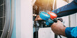 © Nonthanat - Technician is checking air conditioner refrigerant leak.