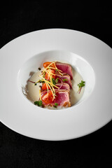 Canvas Print - Exquisite Tuna Tataki Dish on Elegant White Plate with Garnish