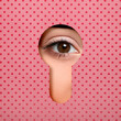 © New Africa - Woman looking through keyhole in pink dotted surface