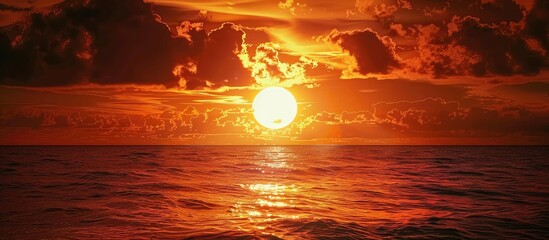 Poster - Beautiful orange-red sunset over the Caspian Sea with the sun in the dark sky, creating a dramatic copy space image.