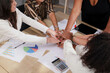 © Altura - Diverse business team showing unity with hands stacked. Teamwork concept.