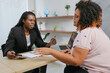 © Altura - Successful transsexual businesswoman talking to a client during a meeting in her office.