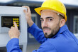 © auremar - closeup of worker pushing buttons on control panel
