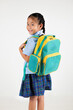 © sorapop - Portrait Back Asian smiling young girl kids kindergarten holding a green and yellow backpack studio shot isolated white background, happy cute little schoolgirl wears school uniform, back to school