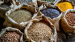 © Synaptic Studio - Assorted whole grains and seeds in paper bags. Whole Grains Month, health and nutrition concept.