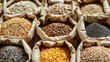 © Synaptic Studio - Assorted whole grains and seeds in paper bags. Whole Grains Month, health and nutrition concept.