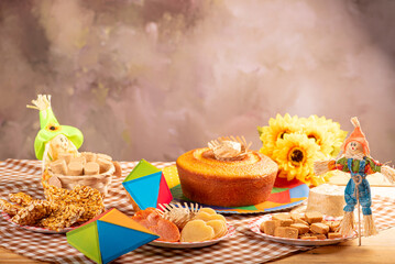 Wall Mural - Festa Junina, beautiful rustic table with dishes containing various types of sweets for Festa Junina in Brazil, selective focus.