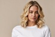 © CS - Young woman in white t-shirt with blonde hair styled in layered waves