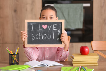 Sticker - Little African-American boy holding chalkboard with text I LOVE SCHOOL in kitchen