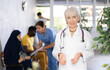 © JackF - Portrait of positive friendly woman doctor in clinic lobby
