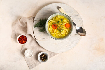 Wall Mural - Bowl of tasty chicken soup and spices on white background