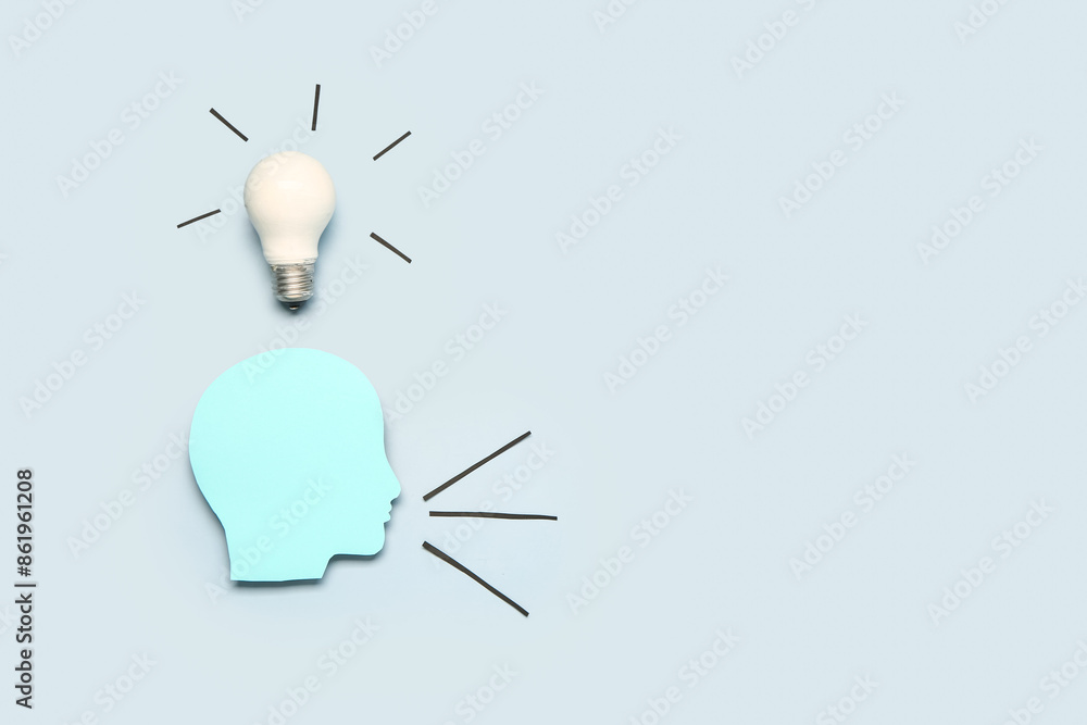 Paper human head with light bulb on grey background. Business idea concept