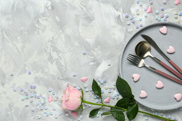 Wall Mural - Beautiful table setting for Valentine's Day with hearts and pink rose on light grunge background
