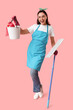 © Pixel-Shot - Pretty young woman with mop and cleaning supplies on pink background