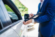 © Phushutter - businessman in suit and car auto insurance agent assess car damage, discussing deductible, claims, coverage options comprehensive and collision insurance, completing necessary forms and appraisals.