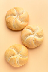 Wall Mural - Delicious kaiser rolls on beige background