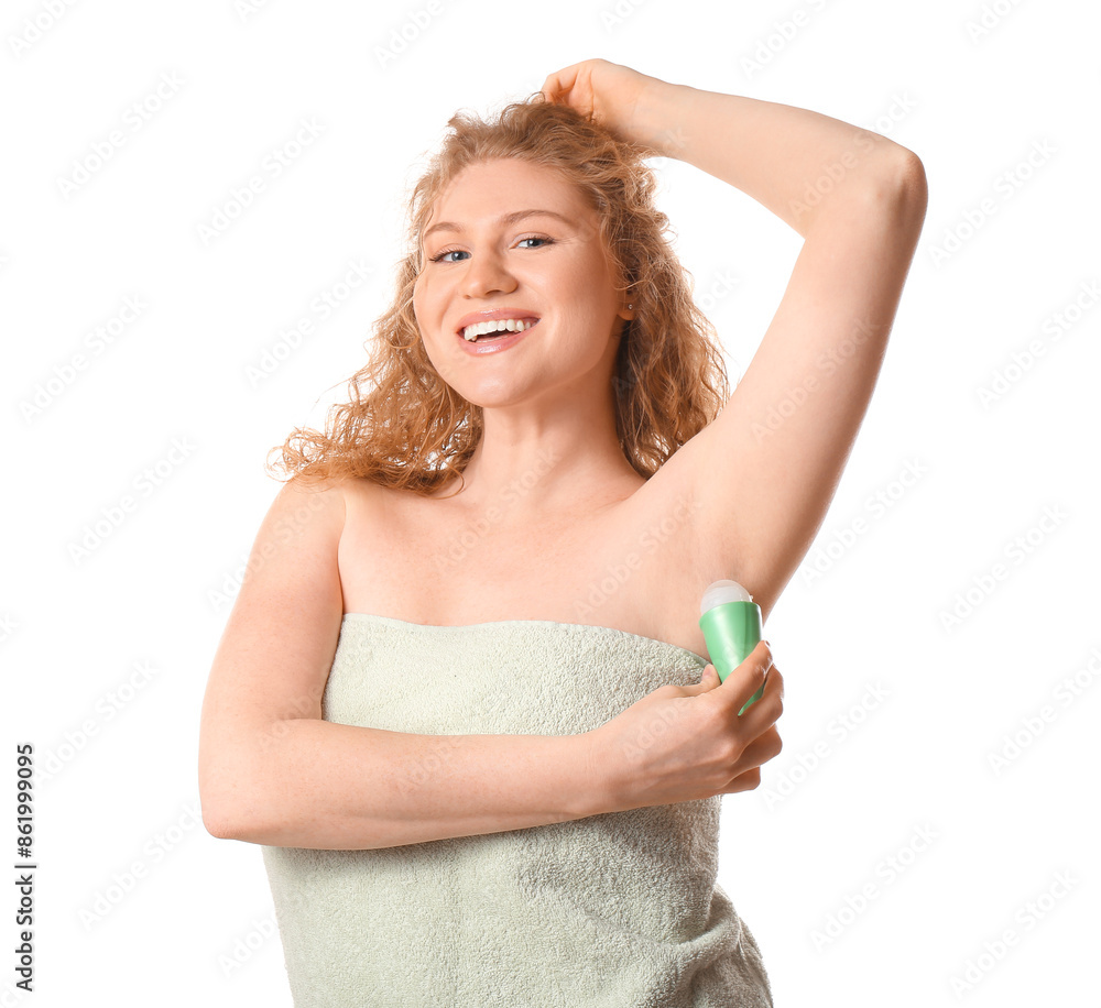 Happy young woman applying deodorant on white background