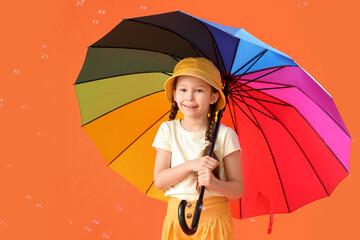 Sticker - Cute little girl with umbrella and soap bubbles on orange background