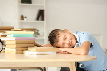 Canvas Print - Teenage boy with books sleeping at table in library