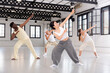 © JackF - Group of young people learning modern dance movements at class together
