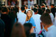 © nicoletaionescu - Smiling Woman in a Crowded Place Standing Out. Special individual being unique in her community opt people