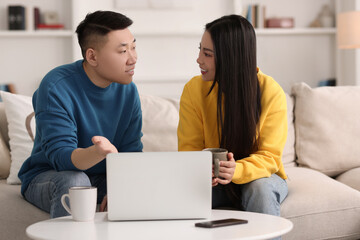 Poster - Happy couple spending time together and using laptop at home