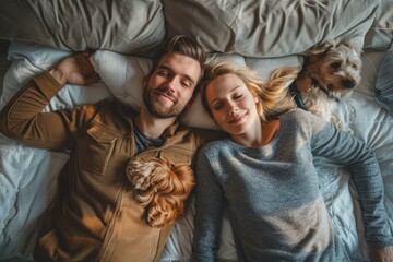 Wall Mural - Photo of a young couple and a dog lying on a living room sofa, top view. The woman had curly red hair and the man was wearing a blue denim shirt