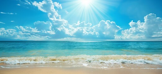 A breathtaking view of a calm beach with gentle waves kissing the sandy shore, beneath a bright sun and fluffy clouds against a clear blue sky.