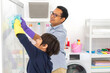 © Art_Photo - Family asian father and kid little boy son doing household cleaning and washing in protective gloves use spray and rag while cleaning window in living room at home.housework, home cleaning concept